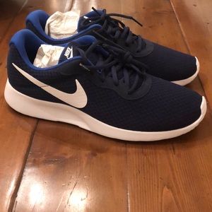 Nike Tanjun sneakers. Brand new—too small on my husband.